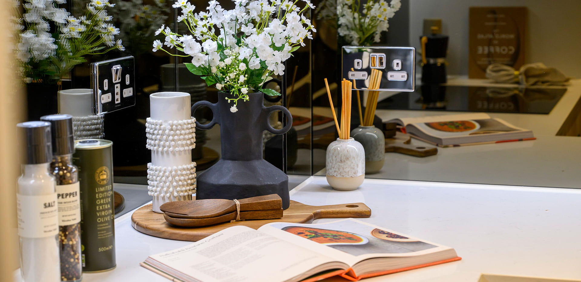 A snapshot of a kitchen worktop, with condiments and recipe books on show