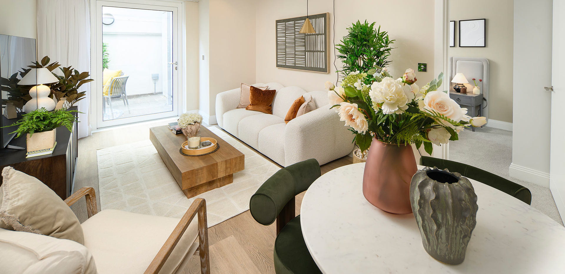 An image of a dining area and living area that attracts bright light from the balcony