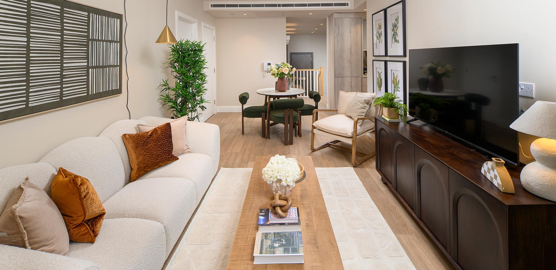 The living area with a large 3-seater sofa and tv stand