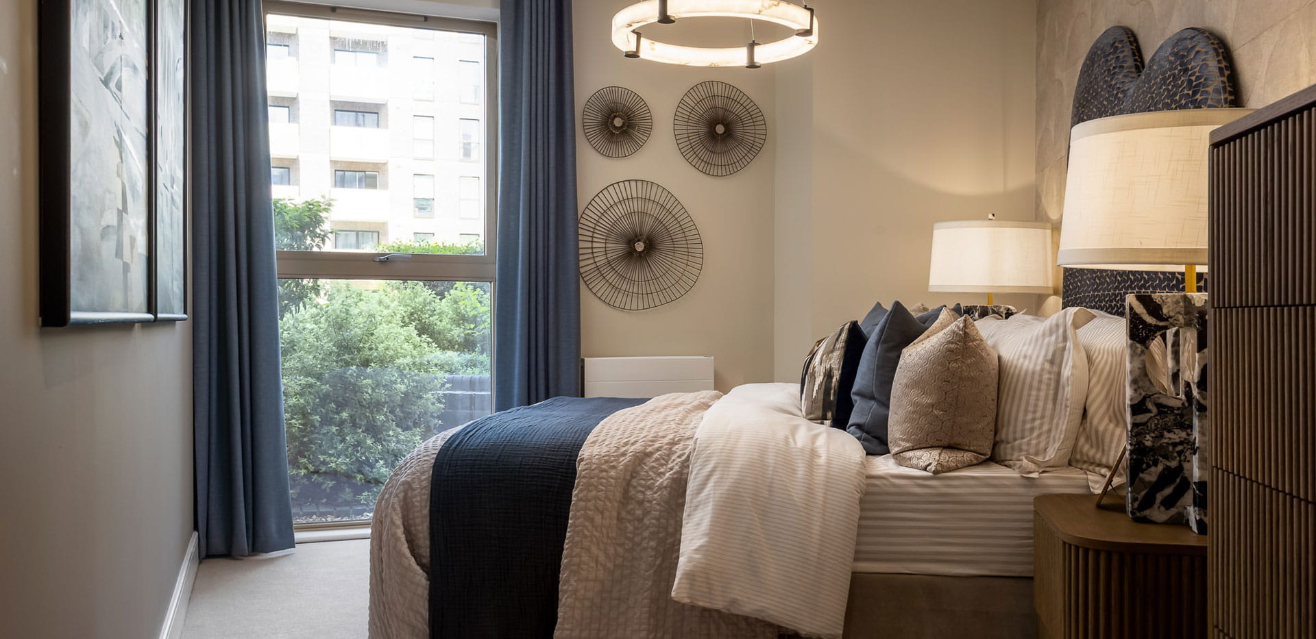Bedroom with wall hangings, ample natural light from window
