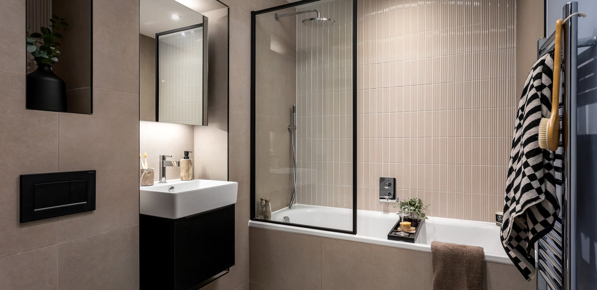 Modern designed shower over bath, wash basin with mirror,and cabinet space
