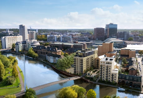 Aerial CGI of modern riverside flats and offices with a footbridge over a canal in a city centre.