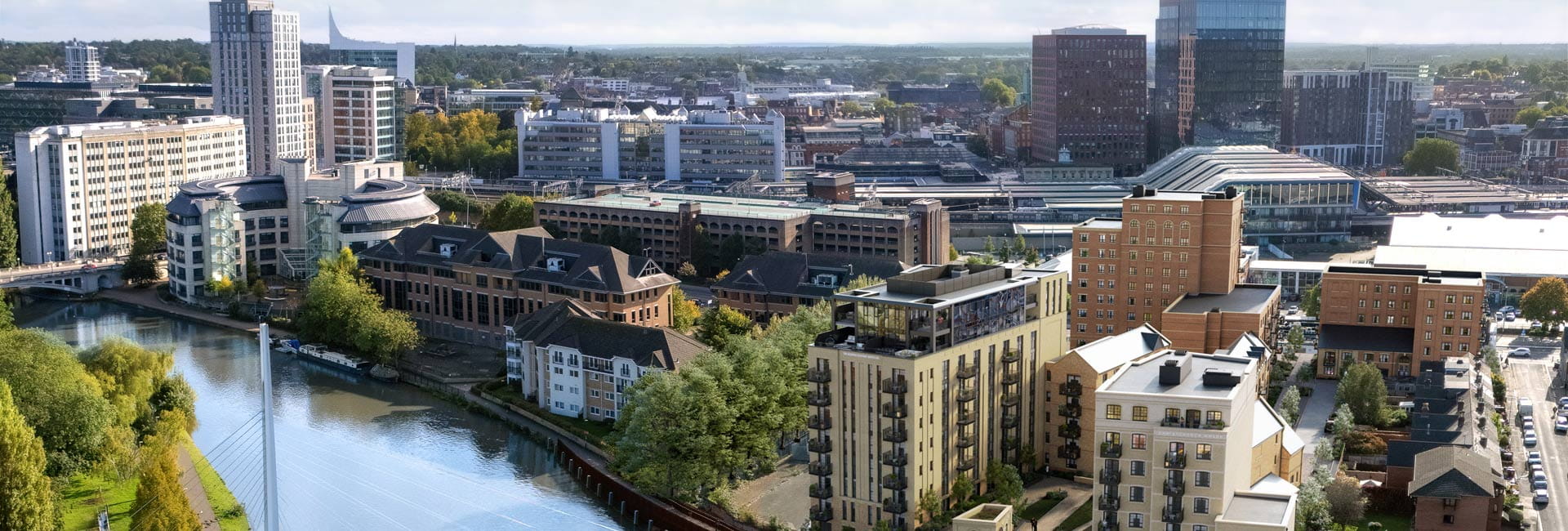 CGI oblique aerial view of a river with landscaped banks and new build apartment blocks adjacent.