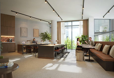 Modern social workspace with shared desk, booth seating, kitchenette and floor-to-ceiling windows.