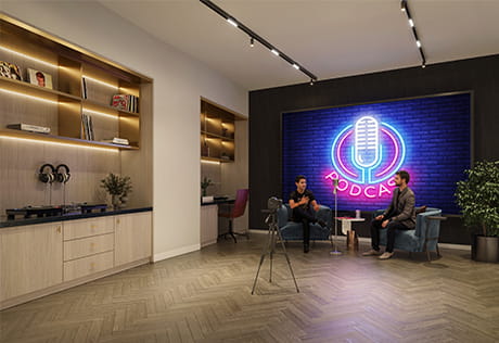 CGI of a modern podcast studio with two hosts, camera tripod, neon microphone sign and shelving.