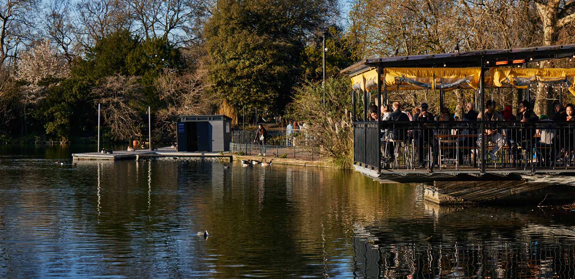 An image of people eating over the river