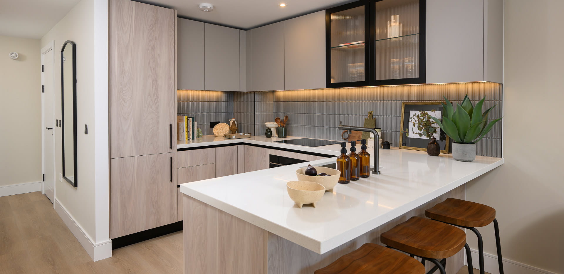 Kitchen with neutral tones, attached island, modern design.