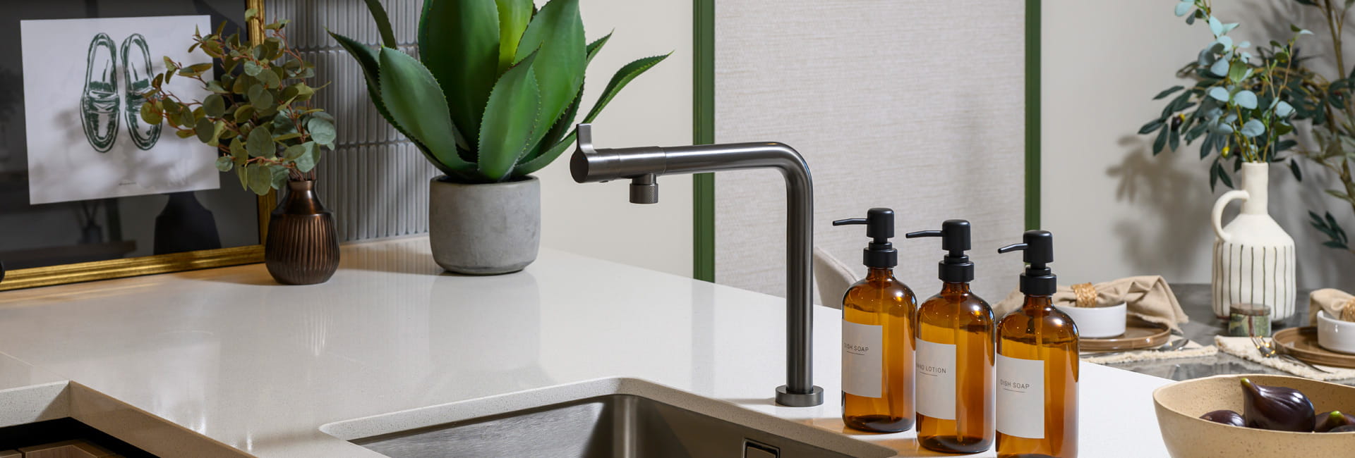 Closeup of kitchen breakfast island sink with countertop decorations
