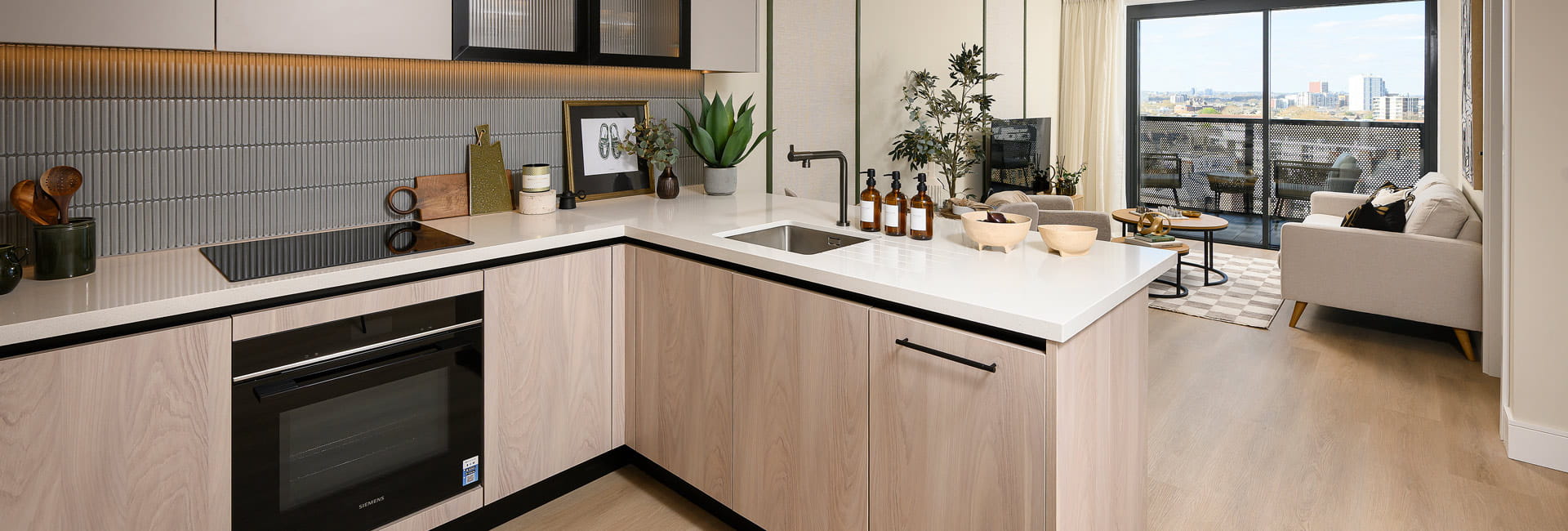 Kitchenette with attached breakfast island, beige surfaces and white countertops