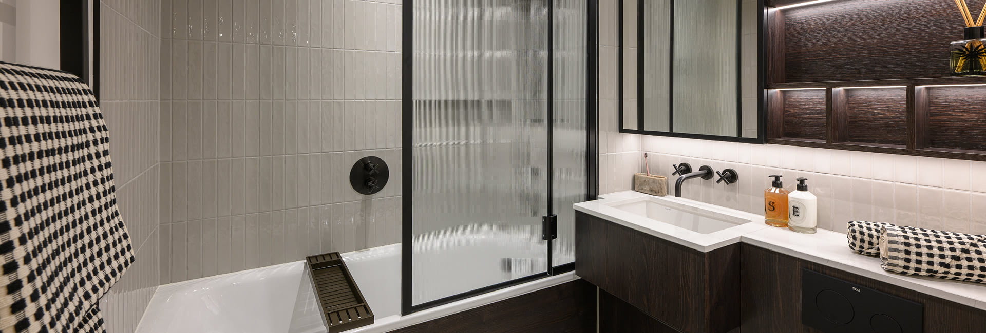 bath, wash basin with cabinet mirror above, heated towel rack and shelving