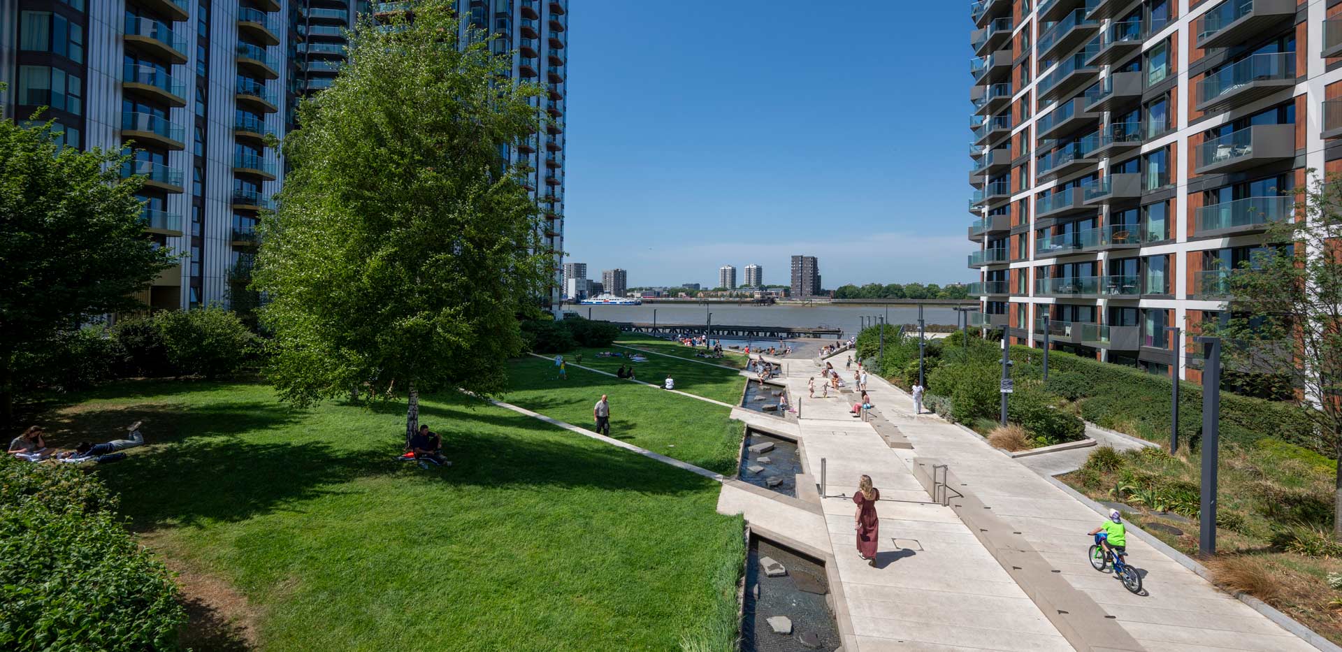 CGI of well kept grassed lawn and clean pedestrian walkway amongst modern flats