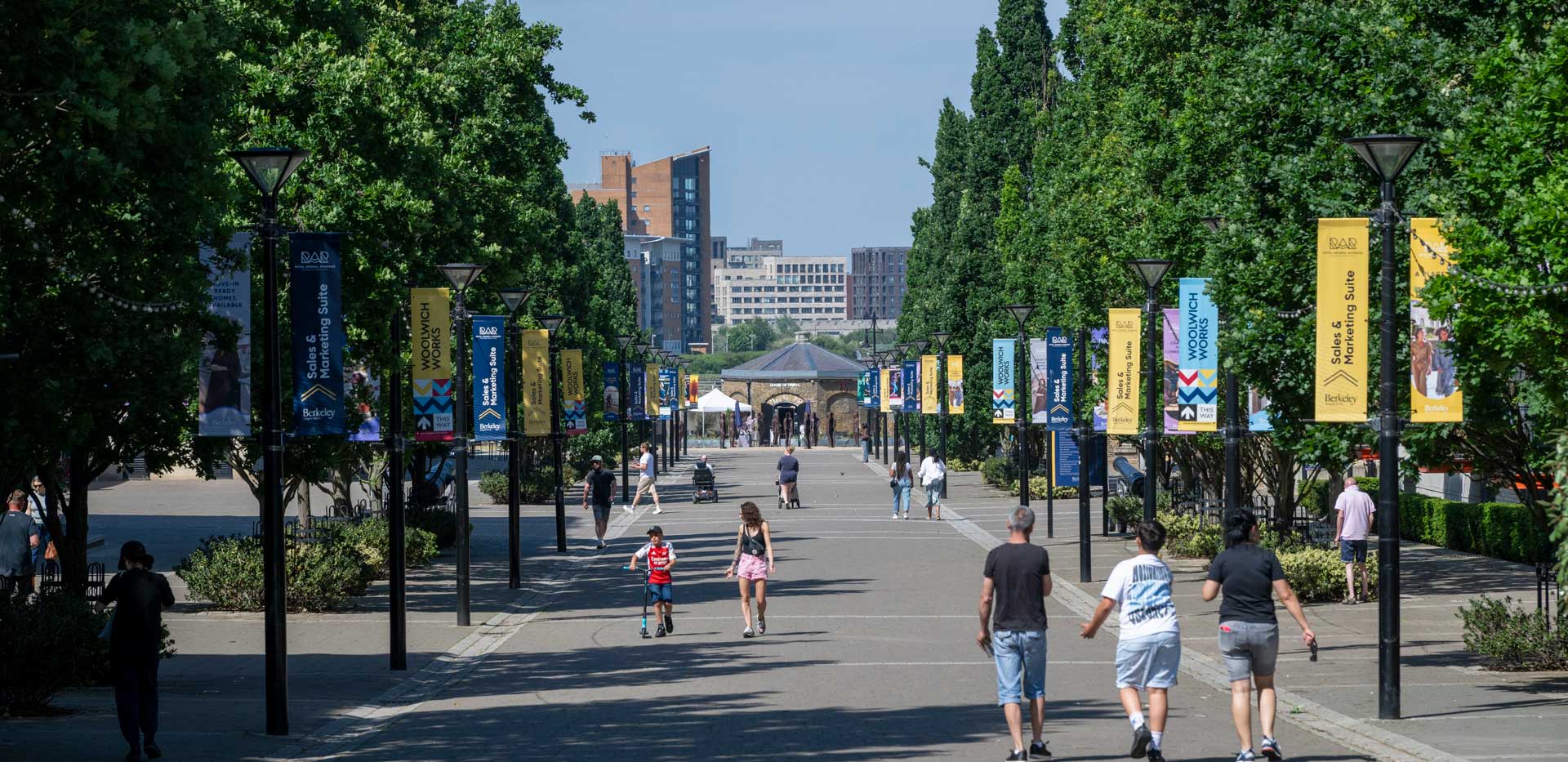 CGI of a view down a long, straight pedestrian path lined with trees either side