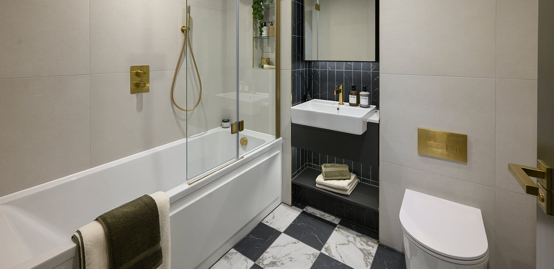 Royal Arsenal Riverside, The Apsley Showhome, spacious bathroom with a dark and gold design