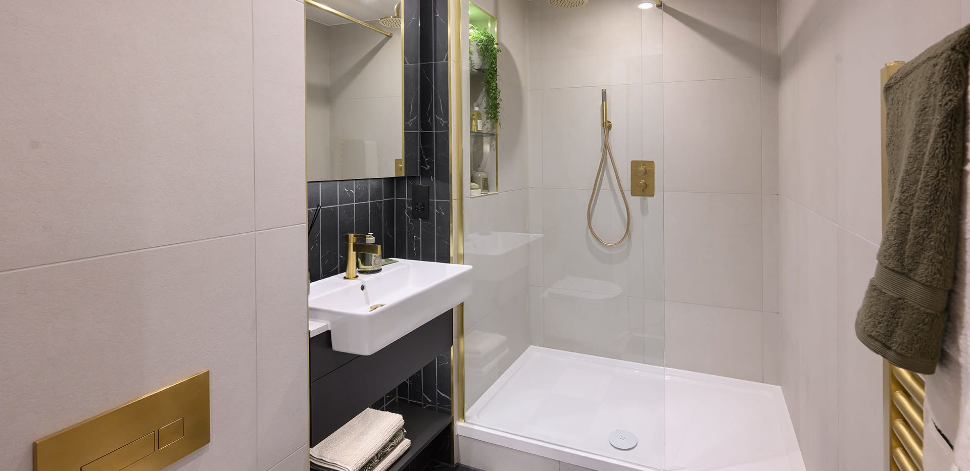 Royal Arsenal Riverside, The Apsley Showhome, spacious bathroom with a dark and gold design