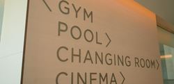 Sign showing directions to the gym, pool, changing room and cinema