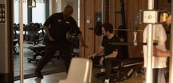 Two men having a discussion in the gym