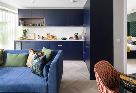 Interior photo of living, kitchen and dining area with blue décor 
