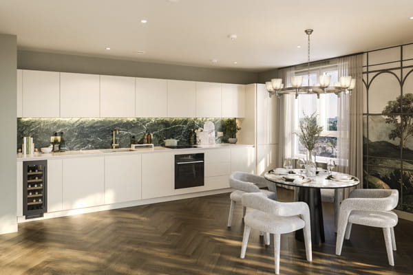 Kitchen with white panels and cupboard surfaces, wine fridge, circular dining table and herringbone pattern wood flooring.