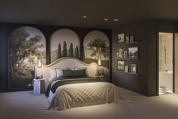 Double bed with elaborate countryside wall paper scenery, shelving units, carpet flooring.