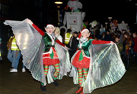 An image of two people dressed as Elves dancing