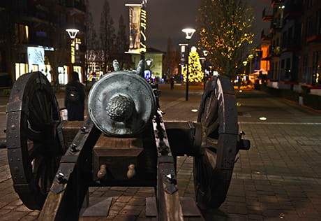 An image of the cannon at Royal Arsenal Riverside looking at the festive decorations around