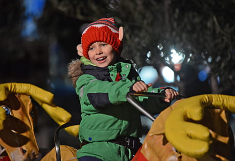An image of child enjoying the christmas festivities