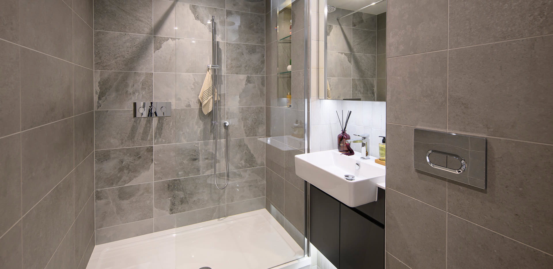 Modern designed bathroom with shower unit and wash basin