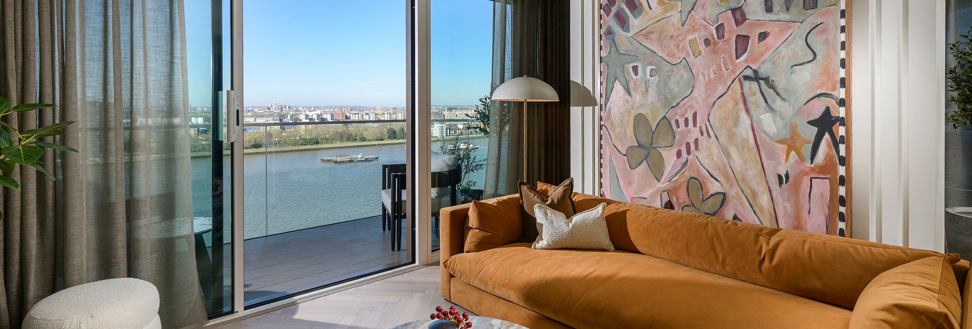 Modern designed living space with chaise lounge and coffee table adjacent to balcony doors