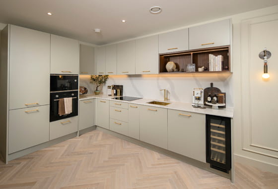 Kitchenette with beige cream cupboards and panels, modern appliances