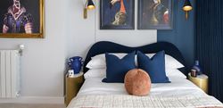 Bedroom with royal blue theme and art on the walls