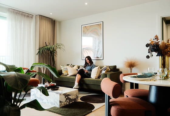 An interior image of someone sat on the living room sofa
