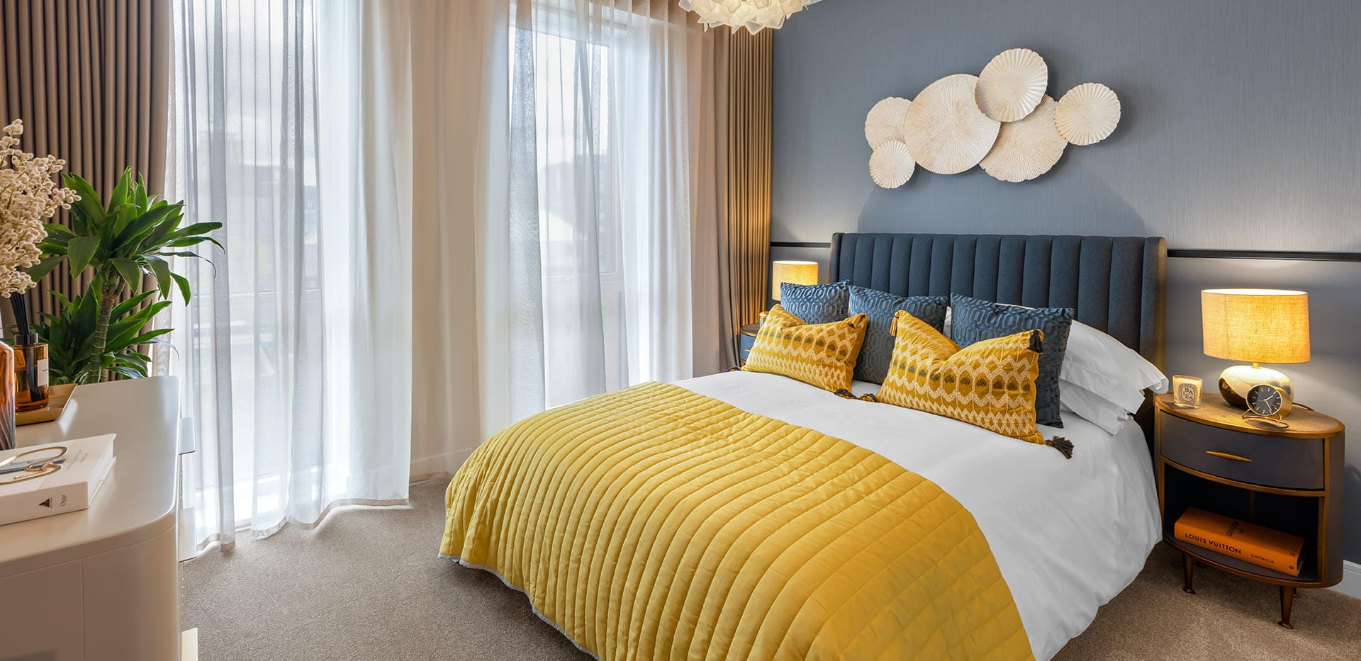 Bedroom with central double bed with blue and yellow bedding