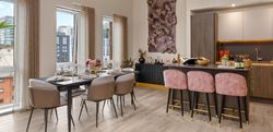 Open dining and kitchen area with neutrally toned décor  