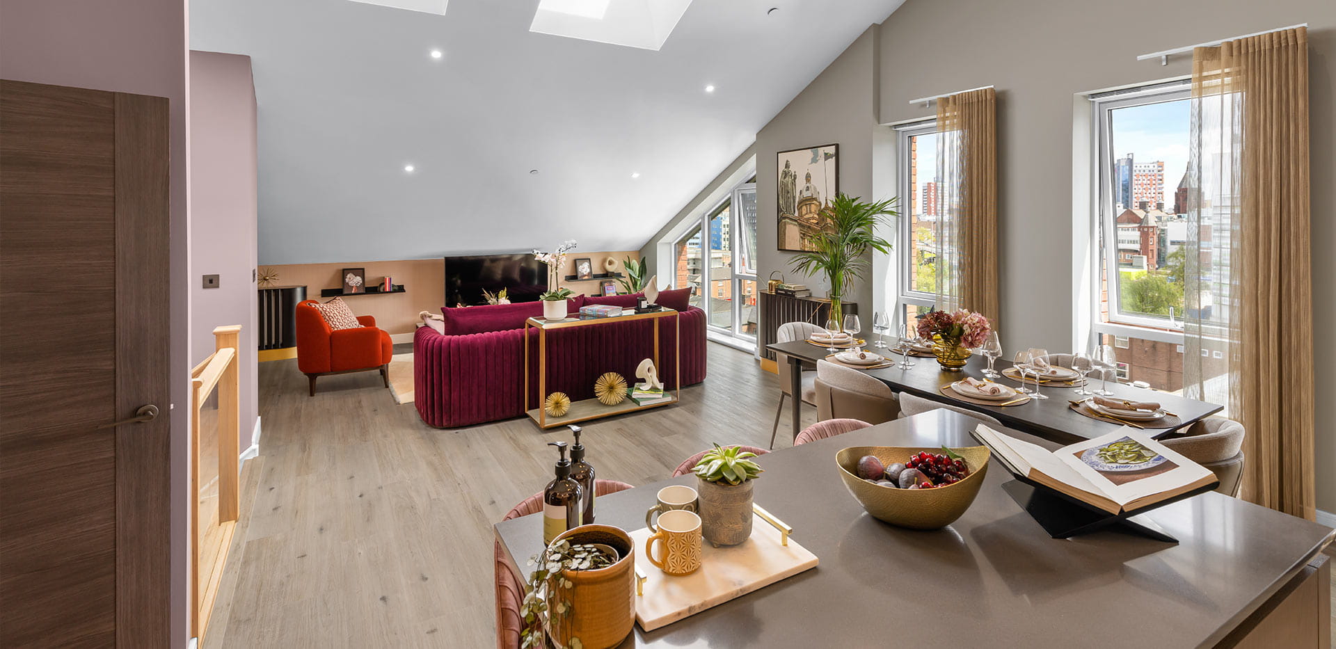 Open dining and kitchen area with neutrally toned décor with living area in the background