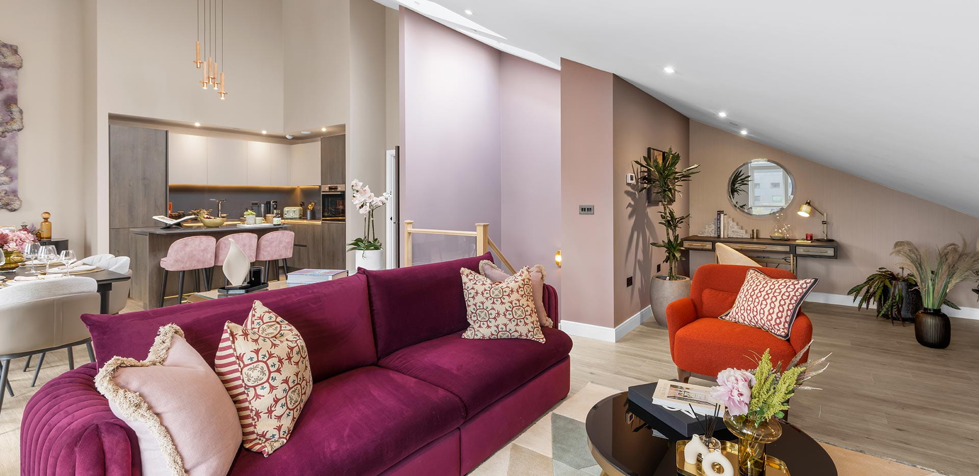 Living area with coffee table and vibrant, brightly coloured sofas