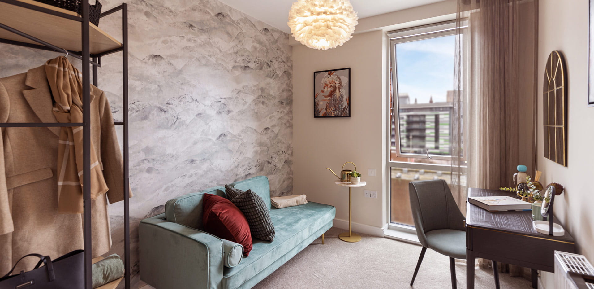 Study area with warmly toned décor and teal sofa 