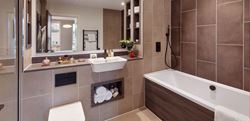 Bathroom with brown tiles and large mirror