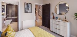 Bedroom with centralised bed, yellow décor and en-suite bathroom