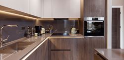 Kitchen with dark wood design contrasted with cream cabinet doors