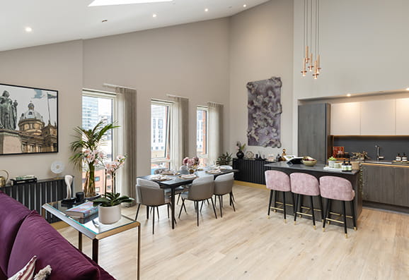 Snow Hill Wharf apartment with slanted ceiling with kitchen in the foreground with living area in the background