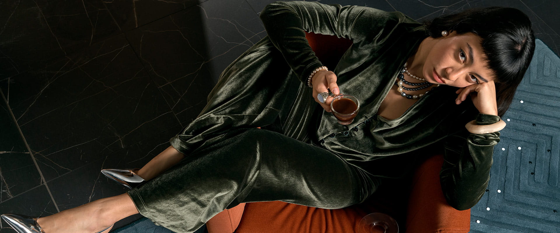 Woman lounging in her South Quay Plaza apartment