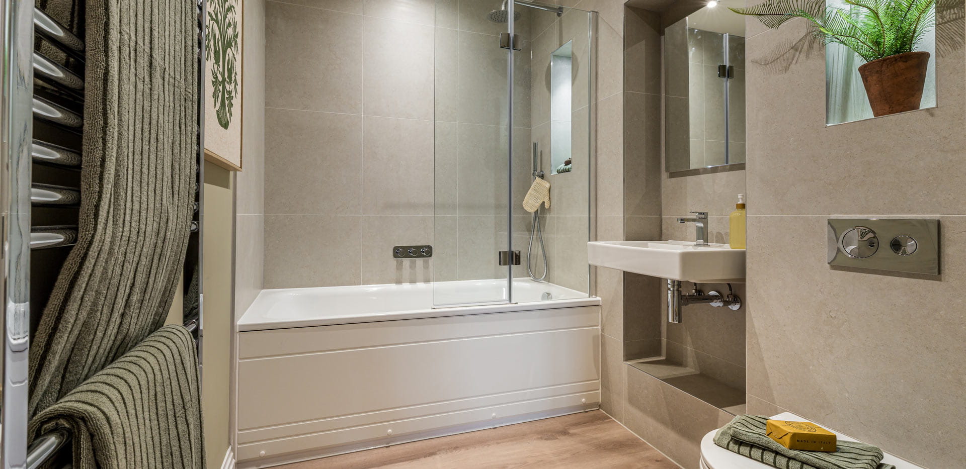 Bath over shower, towel rack, wash basin with wall mirror