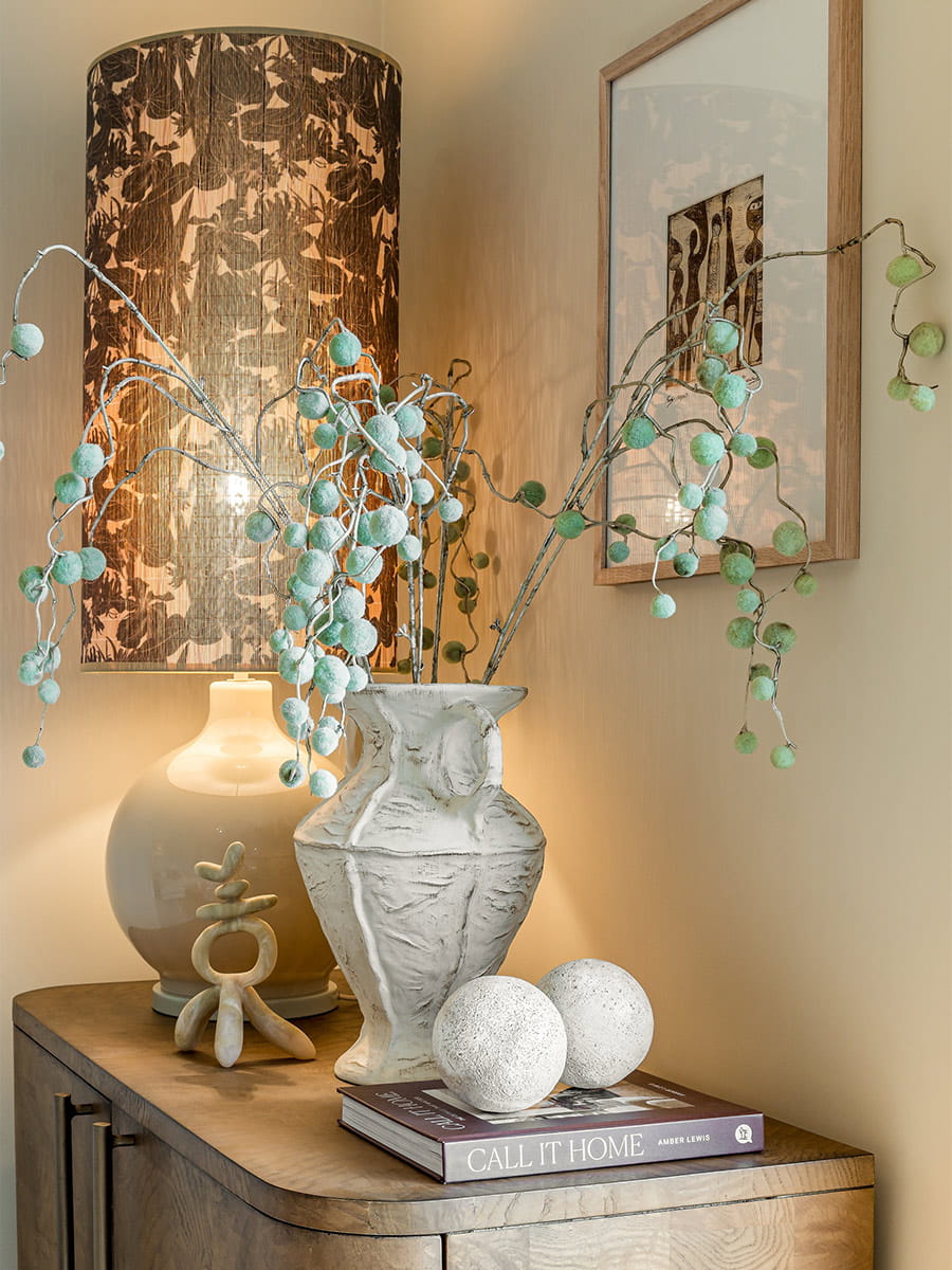Living Area Decorations: cupboard with book, ornaments, vase and lamp on top