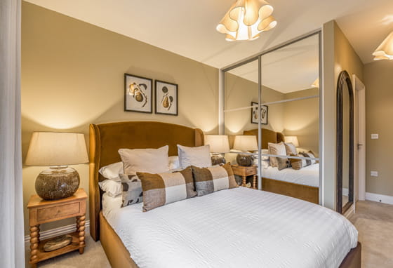 Double bed contemporary design, built-in wardrobe with sliding mirrors.