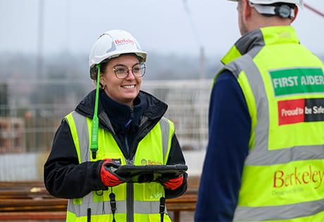 Two people on construction site wearing Berkeley branded PPE