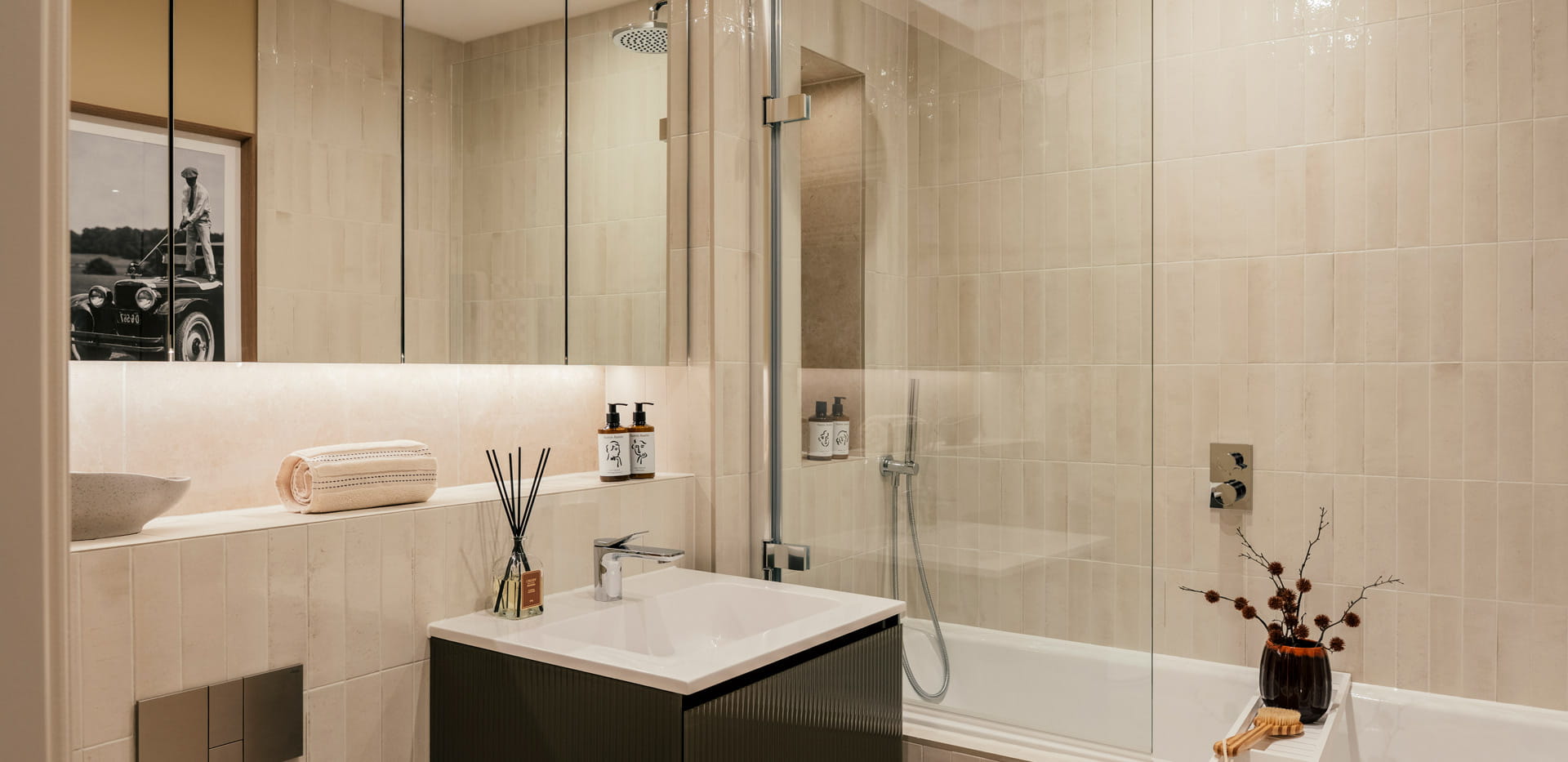 Bathroom with shower over bath, wash basin with cabinet mirror and shelving.