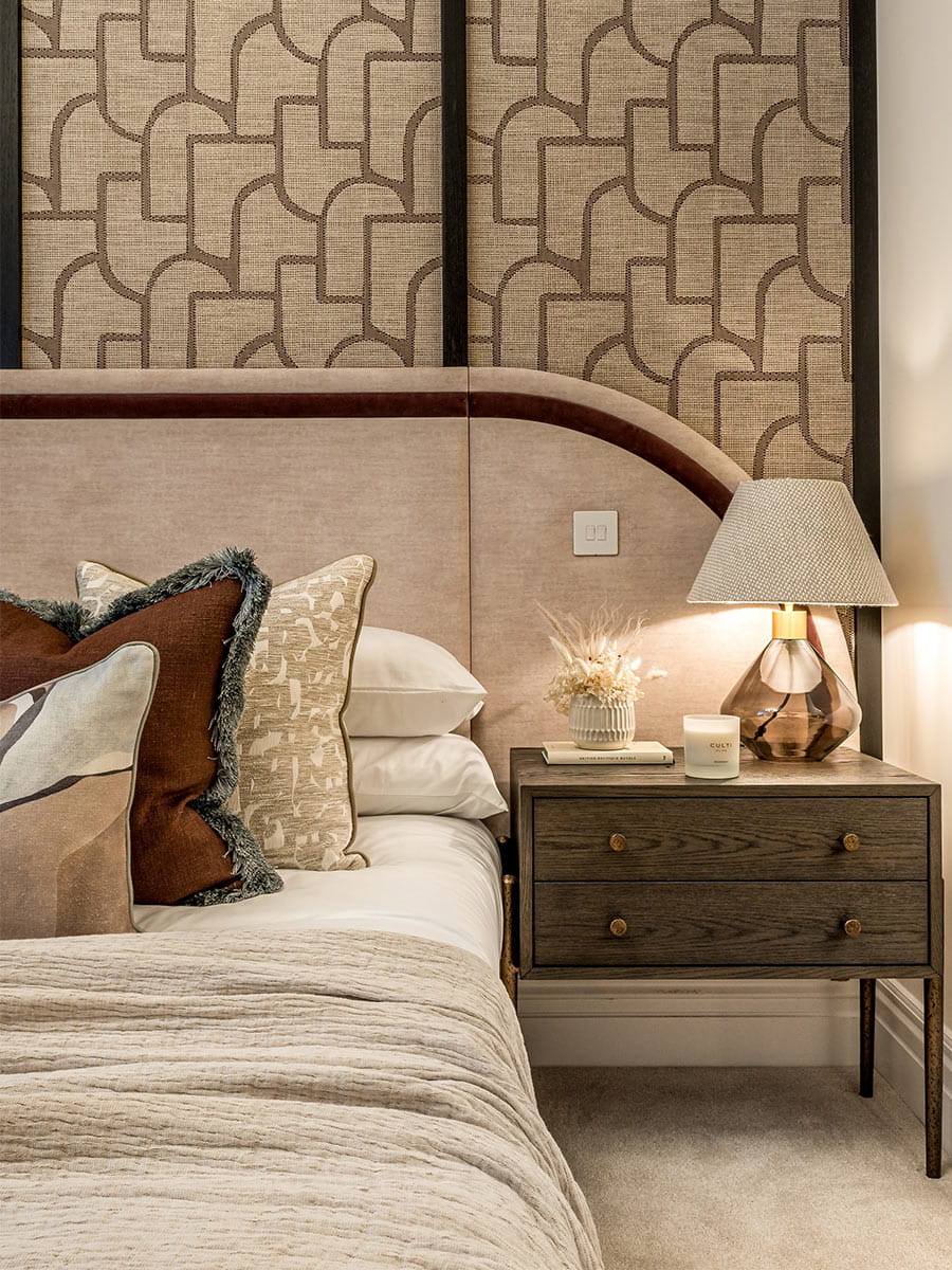 A close up image of the Bed and Night Stand at Sunningdale Park