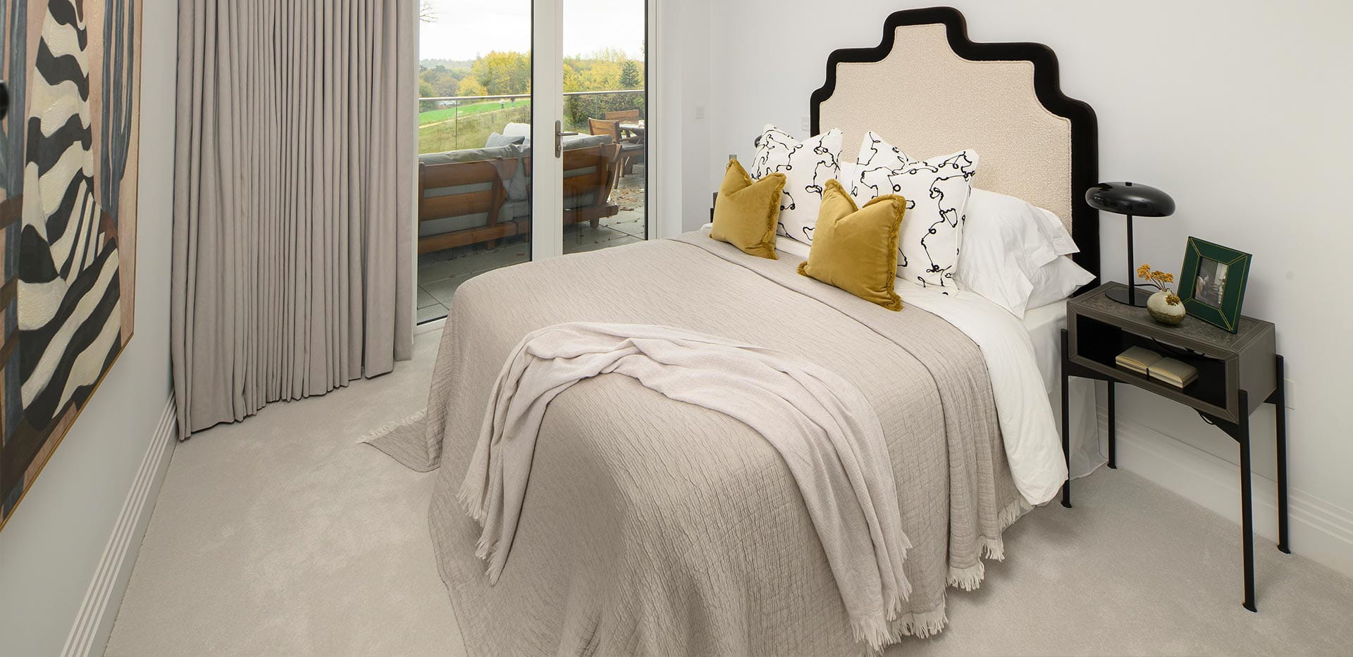 An interior Bedroom with yellow pillows image at The Pavilion at Sunningdale Park