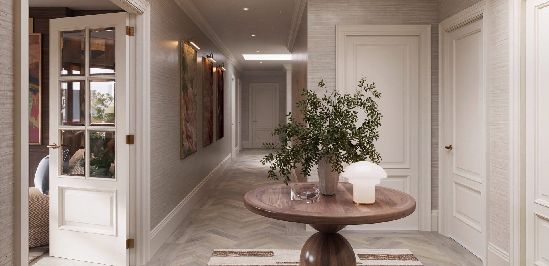 hallway with white-light-grey walls, central circular, decorated table, wall hangings.