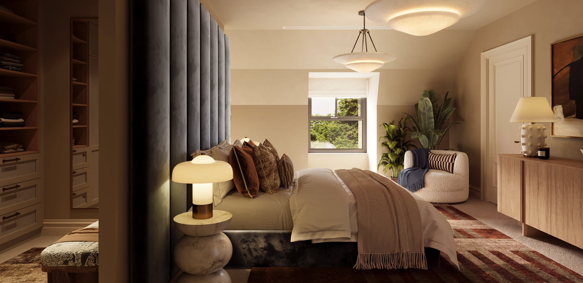 A view of a bedside, rug beneath, armchair next to window and walk-in wardrobe behind partition.